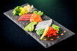 Sashimi, a Japanese delicacy consisting of fresh raw fish  sliced into thin pieces (salmon fillet, tuna fillet, cod fillet)