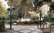 View of urban Gabriel Miro city square in downtown Alicante, Spain, with water fountains and matures trees.
