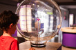 © ADDICTIVE STOCK - Curious child engaging with science exhibit at museum