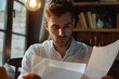 © wolfhound911 - Young man entrepreneur analyzing papers at office close up. Businessman wor