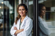 © ADDICTIVE STOCK - Confident female doctor smiling near hospital entrance. Generative AI image