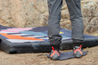 © ADDICTIVE STOCK - Anonymous climber stands on a crash pad, ready to tackle the boulder, showcasing the specialized climbing shoes