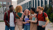 © Yuliia - University friendship funny speaking emotional joyful diverse people teens high school pupils happy multiracial friends classmates multiethnic students smiling talking laughing walking city outdoors