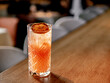 Glass of frozen citrus cocktail with triple sec on bar counter in restaurant interior background, copy space