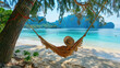 © Jasmina - Woman relaxes and enjoys the sun on vacation at the beach in a wicker hammock