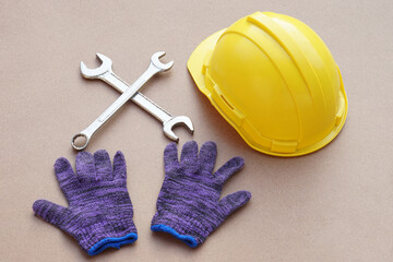 Handyman kits with yellow protective hard hat, gloves and wrenches. Concept, handyman or mechanic tools. Equipment for fixing or repairing, renovation in daily life.                      