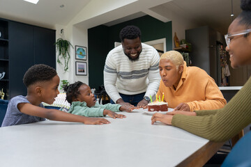 Wall Mural - Family with children (2-3, 6-7, 12-13) celebrating birthday at home