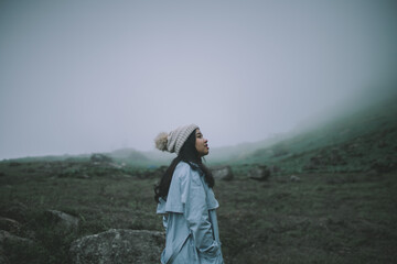 woman in a sweater looking at the fog