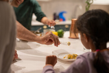 Wall Mural - Father serving meal to daughter