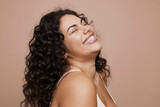 Fototapeta Londyn - Studio shot of smiling young woman with curly hair