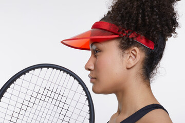 Wall Mural - Profile of woman with tennis rocket and red sunvisor