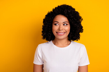 Wall Mural - Photo of nice woman with perming coiffure dressed white t-shirt look at discount empty space isolated on vibrant yellow color background