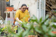 Young woman with down syndrome planting flowers in garden