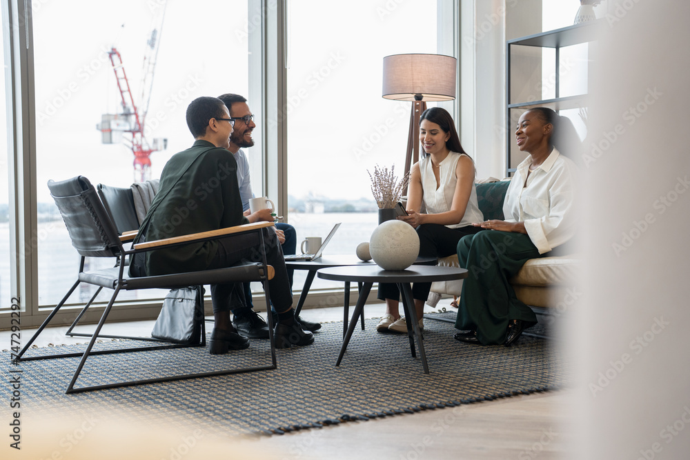 Business people having meeting in office lobby Stock Photo | Adobe Stock