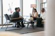 © Cultura Creative - Business people having meeting in office lobby