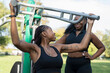 Young female friends working out in outdoor gym
