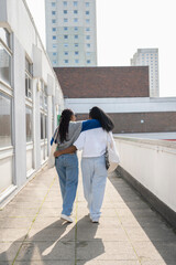 Wall Mural - Young female couple walking in city