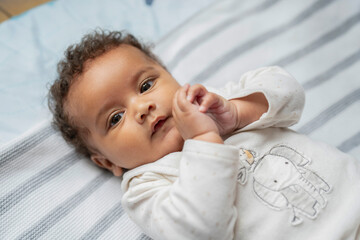 Canvas Print - Portrait of baby girl with curly hair and brown eyes