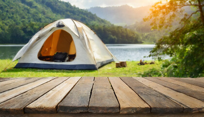 wooden table in blurred camping tent and mountain on a beautiful sunny day. cool and relaxing concep