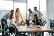 © standret - On the meeting, discussing the plans. Group of office workers are together indoors