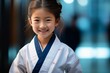 a student Girl in a karate class showcases her inner strength through a steely gaze and determined countenance.