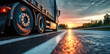 Leinwandbild Motiv Close-up of a cargo truck on the road at sunset