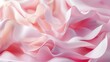 Light pink flowing waves of soft fabric create an elegant and delicate background.