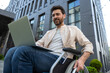 © zinkevych - Bearded young man sitting on a wheelchair and watching something online