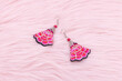 Chinese earrings, Close up of a pair of Chinese style earrings on a pink background. Antique earrings for women.