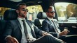 © Helen-HD - Two businessmen in suits and sunglasses are sitting in the back seat of a luxury car. They are drinking champagne and looking out the window. The car is driving through a city street.