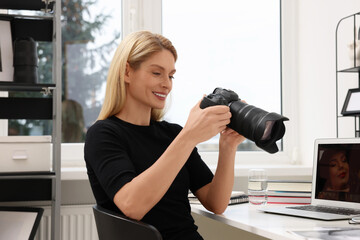 Poster - Professional photographer with digital camera at table in office