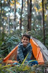 Wall Mural - Smiling boy near camping tent in forest