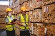 © chokniti - Man and woman workers with clipboard discussing working and checking stock inventory wood plank material for making wooden pallet products at warehouse industrial factory, woodwork production