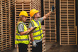 © chokniti - Man and woman workers with clipboard discussing working and checking stock inventory wood plank material for making wooden pallet products at warehouse industrial factory, woodwork production