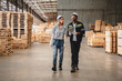 © chokniti - Man and woman workers with clipboard discussing working and checking stock inventory wood plank material for making wooden pallet products at warehouse industrial factory, woodwork production
