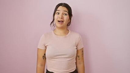 Sticker - Hilarious young hispanic woman sporting a bloated, cheek-inflated, funny face! puffing cheeks full of air in crazy joy, over isolated pink wall - a breathtaking sight!