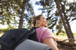 © Wavebreak Media - A young Caucasian woman with a backpack gazes into the distance on a hike