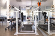 © Wavebreak Media - A treadmill flanked by mobility assistance equipment dominates the foreground