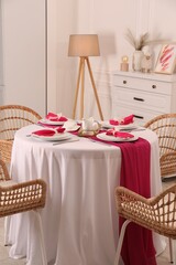 Canvas Print - Color accent table setting. Plates, cutlery and pink napkins in dining room