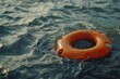 An orange life preserver floating in the water, suitable for water safety concepts.