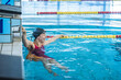 © 24K-Production - Woman swimmer happy at the finish of a race in the pool at competition
