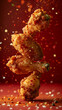 © IBEX.Media - crispy and crunchy fried chicken surrounded by spices flying in the air against a plain red background