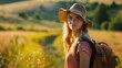 © JubkaJoy - Young Woman Hiking in a Meadow during Countryside Travel, Summer traveling and Vacation adventure concept