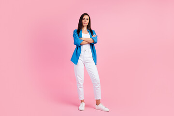 Canvas Print - Full size photo of serious confident strict girl dressed blue shirt white trousers keep palms folded isolated on pink color background