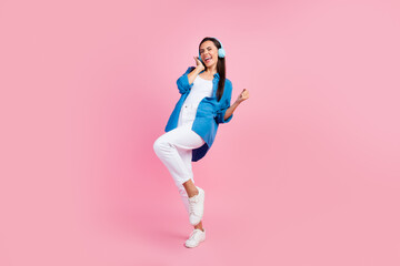 Canvas Print - Full size photo of overjoyed nice girl dressed blue shirt white trousers sing song in headphones isolated on pink color background