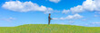 © juanjo - Solitude in Serenity: Man in Suit Standing Alone on a Lush Green Hill Under Blue Sky