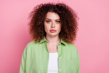 Wall Mural - Photo of serious confident pleasant woman with perming coiffure dressed green shirt look at camera isolated on pink color background