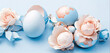 Composition of Easter eggs and rosebuds on a blue background