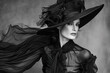 A model wearing a dramatic hat, with a flowing dress and long gloves