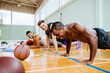 © Marko Geber - Exhausted basketball player resting on the court with teammates